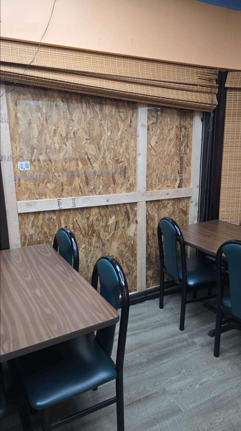 Restaurant dining room with a boarded-up window