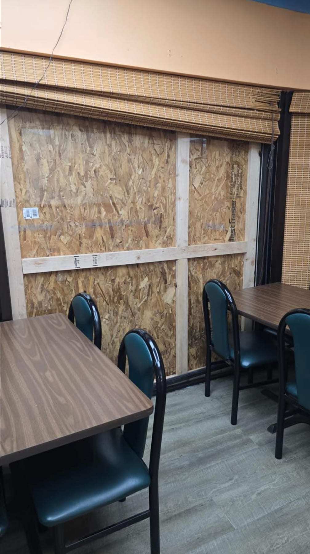 Restaurant dining room with a boarded-up window